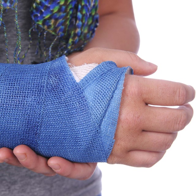 Pols in het gips met blauw verband erom